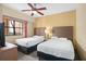 Bedroom with two twin beds and a ceiling fan at 12538 Floridays Resort Dr # 411, Orlando, FL 32821