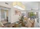 Open concept dining room with glass table and view of bathroom at 12538 Floridays Resort Dr # 411, Orlando, FL 32821