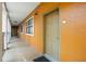 Building hallway with orange walls and tan doors at 12538 Floridays Resort Dr # 411, Orlando, FL 32821