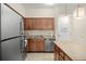 Updated kitchen featuring wood cabinets, granite counters & stainless steel appliances at 12538 Floridays Resort Dr # 411, Orlando, FL 32821