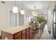 Open concept kitchen with island, dining area, and access to living room at 12538 Floridays Resort Dr # 411, Orlando, FL 32821