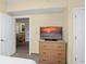 Living room with dresser and TV showing sunset at 12538 Floridays Resort Dr # 411, Orlando, FL 32821