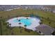 Community pool with a clubhouse and surrounding homes at 1280 Tupelo Trl, Haines City, FL 33844