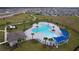 Community pool with surrounding deck and lounge chairs at 1280 Tupelo Trl, Haines City, FL 33844