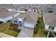 House with gray exterior, white garage door, and landscaped yard at 1280 Tupelo Trl, Haines City, FL 33844