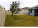 Large backyard with grassy area and privacy fence at 1280 Tupelo Trl, Haines City, FL 33844