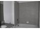 Bathroom with granite countertop, gray tile, and bathtub at 1280 Tupelo Trl, Haines City, FL 33844