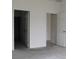 Empty bedroom with two doors and neutral colored walls at 1280 Tupelo Trl, Haines City, FL 33844