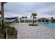 Community pool with shade structures and lounge chairs at 1280 Tupelo Trl, Haines City, FL 33844