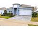 One-story home with gray exterior, white garage door, and landscaped yard at 1280 Tupelo Trl, Haines City, FL 33844