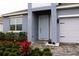 Light blue front door with landscaping and brick walkway at 1280 Tupelo Trl, Haines City, FL 33844