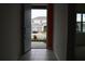 Open door reveals view of street and parked vehicle at 1280 Tupelo Trl, Haines City, FL 33844