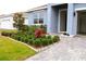 Landscaped front yard with walkway to house entrance at 1280 Tupelo Trl, Haines City, FL 33844