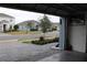 View from garage showing street and neighborhood homes at 1280 Tupelo Trl, Haines City, FL 33844