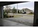View from garage showing street and neighborhood homes at 1280 Tupelo Trl, Haines City, FL 33844