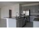 Kitchen island with granite countertop and stainless steel dishwasher at 1280 Tupelo Trl, Haines City, FL 33844