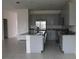 Modern kitchen with gray cabinets, granite countertops, and stainless steel appliances at 1280 Tupelo Trl, Haines City, FL 33844