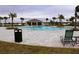 Community pool with lounge chairs and a pool house at 1280 Tupelo Trl, Haines City, FL 33844
