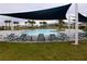 Community pool with lounge chairs and shade structures at 1280 Tupelo Trl, Haines City, FL 33844