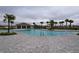 Community pool with lounge chairs and a pool house at 1280 Tupelo Trl, Haines City, FL 33844