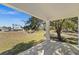 Covered patio overlooking backyard with large oak tree at 13380 Sw 60Th Court Rd, Ocala, FL 34473