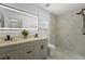 Modern bathroom with double vanity, marble tile, and walk-in shower at 13380 Sw 60Th Court Rd, Ocala, FL 34473