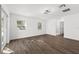Spacious bedroom with wood-look flooring and access to a bathroom at 13380 Sw 60Th Court Rd, Ocala, FL 34473