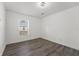 Spacious bedroom with large window and wood-look flooring at 13380 Sw 60Th Court Rd, Ocala, FL 34473