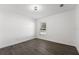 Simple bedroom with wood-look flooring and a window at 13380 Sw 60Th Court Rd, Ocala, FL 34473