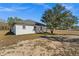 White house exterior with grey roof and landscaping at 13380 Sw 60Th Court Rd, Ocala, FL 34473