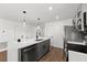 Modern kitchen with gray cabinets, white quartz countertops, and stainless steel appliances at 13380 Sw 60Th Court Rd, Ocala, FL 34473