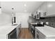 Modern kitchen with gray cabinets, white quartz countertops, and stainless steel appliances at 13380 Sw 60Th Court Rd, Ocala, FL 34473