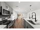 Modern kitchen with gray cabinets, quartz countertops, and stainless steel appliances at 13380 Sw 60Th Court Rd, Ocala, FL 34473