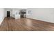 Open concept living area with wood-look floors and kitchen views at 13380 Sw 60Th Court Rd, Ocala, FL 34473