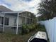 View of backyard with fence and patio and shrubbery visible at 143 Glasgow Ct, Davenport, FL 33897
