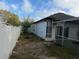 Side view of backyard with mature trees and lawn behind the screened patio at 143 Glasgow Ct, Davenport, FL 33897