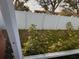 Fenced backyard with lawn and shrubs at 143 Glasgow Ct, Davenport, FL 33897