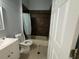 This bathroom includes a shower, a toilet and a vanity at 143 Glasgow Ct, Davenport, FL 33897