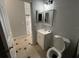 Bathroom featuring a vanity, toilet, mirror, and tiled flooring at 143 Glasgow Ct, Davenport, FL 33897