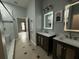 Bathroom featuring double sinks and a tile-surround shower at 143 Glasgow Ct, Davenport, FL 33897