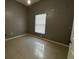 This cozy bedroom features a tile floor and a window at 143 Glasgow Ct, Davenport, FL 33897