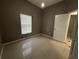 Simple bedroom with a window with blinds, a white door, and tile flooring at 143 Glasgow Ct, Davenport, FL 33897