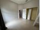 This bedroom features tile floors, neutral paint and bi-fold closet at 143 Glasgow Ct, Davenport, FL 33897