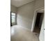 This bedroom features tile floors, a window, and an open closet at 143 Glasgow Ct, Davenport, FL 33897