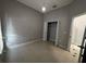 Cozy bedroom featuring a closet with double doors, tile flooring, and modern lighting at 143 Glasgow Ct, Davenport, FL 33897