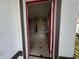 Inviting entryway with tile flooring, a red-framed door, and a view into the spacious living area at 143 Glasgow Ct, Davenport, FL 33897
