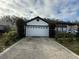 Charming single-story home featuring a two-car garage, well-kept landscaping, and a cozy front porch at 143 Glasgow Ct, Davenport, FL 33897