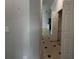 This hallway has tile floors and an adjacent kitchen at 143 Glasgow Ct, Davenport, FL 33897