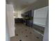 Kitchen and dining area with stainless appliances, ample counter space, and tiled floors at 143 Glasgow Ct, Davenport, FL 33897
