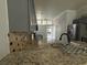 Updated kitchen with granite countertops, stainless steel appliances, and stylish backsplash at 143 Glasgow Ct, Davenport, FL 33897